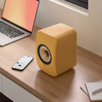 KEF LSX II wireless bookshelf speakers, in amber haze and cotton white