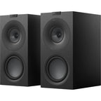 Pair of KEF Q Concerto Meta passive bookshelf speakers with sleek black cabinets and detailed driver grilles, ideal for home audio.