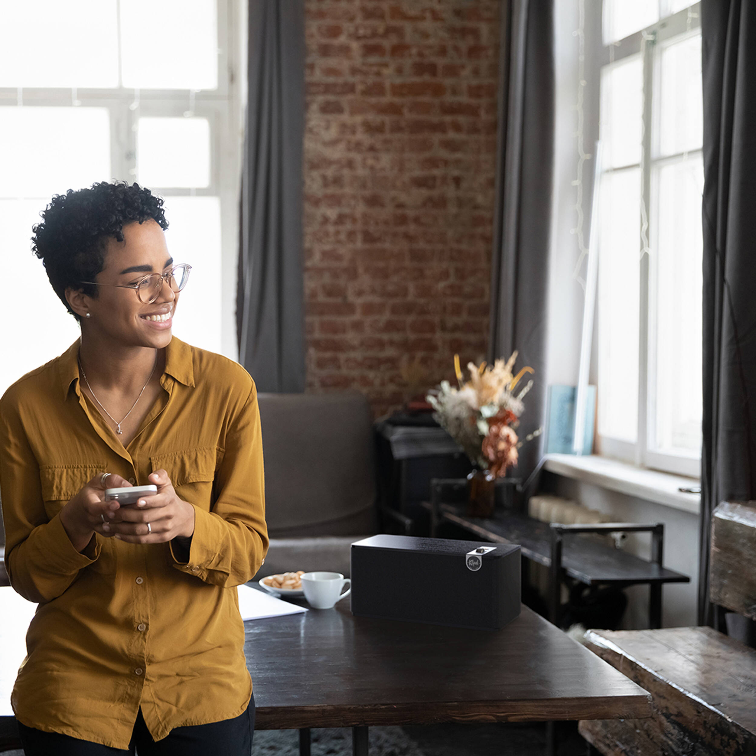 Klipsch The Three Plus wireless speaker, lifestyle in a living room in black