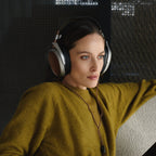 Meze Audio Poet wired headphones with sleek design and over-ear cushions, featuring black and silver accents.