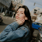 Woman wearing the Meze Audio Alba S in-ear monitors outdoors