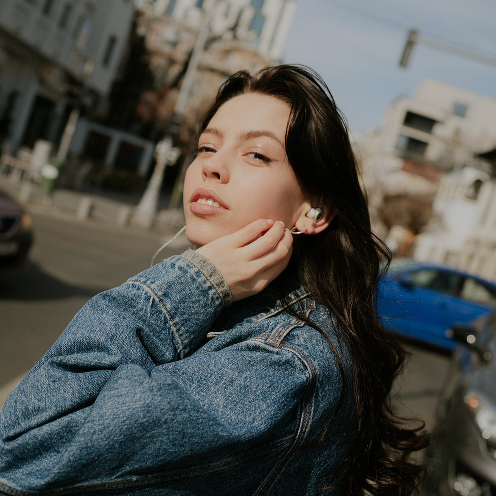 Woman wearing the Meze Audio Alba S in-ear monitors outdoors