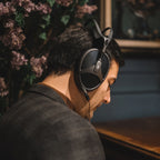 Meze Audio Elite Tungsten wired headphones with sleek design and cushioned ear cups, shown from a side angle.