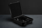 Open suitcase with Meze Audio Empyrean II wired headphones displayed inside, showcasing sleek design and premium craftsmanship.