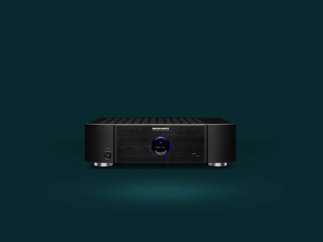 Marantz MM7025 stereo amplifier with dual channels and sleek black design, featuring control knobs and input ports on the front panel.
