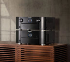 Marantz MM7055 stereo amplifier in black, showcasing front panel with multiple control knobs and input options.