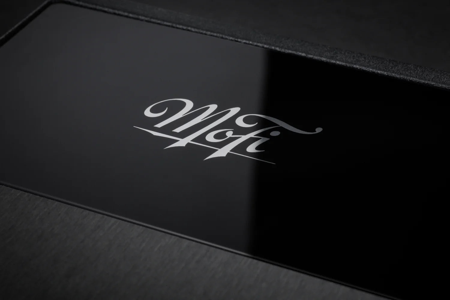 Close-up of MoFi Electronics UltraPhono phono preamp showing input and control knobs on a sleek black device.