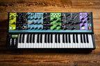 Moog Matriarch synthesizer with multiple knobs, patch points, and keyboard, showcasing its analog electronic music production interface.