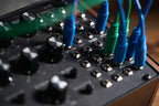 Close-up of Moog Labyrinth synthesizer showing detailed control knobs and vintage-inspired design elements.