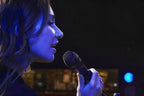 Shure Nexadyne 8/S dynamic microphone on stage, ready for live performance, with a professional audio setup.