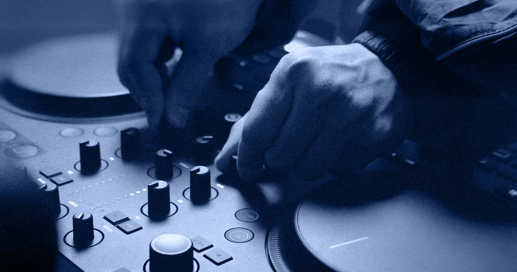 Native Instruments Traktor MX2 DJ controller with jog wheels, faders, and controls for professional DJ mixing.