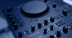 Native Instruments Traktor MX2 DJ controller with dual jog wheels, mixer knobs, and performance pads for digital DJing.