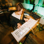 Novation Launchkey 49 MK4 MIDI keyboard, in white, lifestyle setting