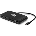 OWC Thunderbolt Mini Dock connected to a laptop, showing multiple ports for USB, HDMI, and power, compact and versatile docking station.