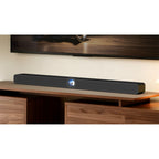 WiiM Bar Black on a media console below a TV