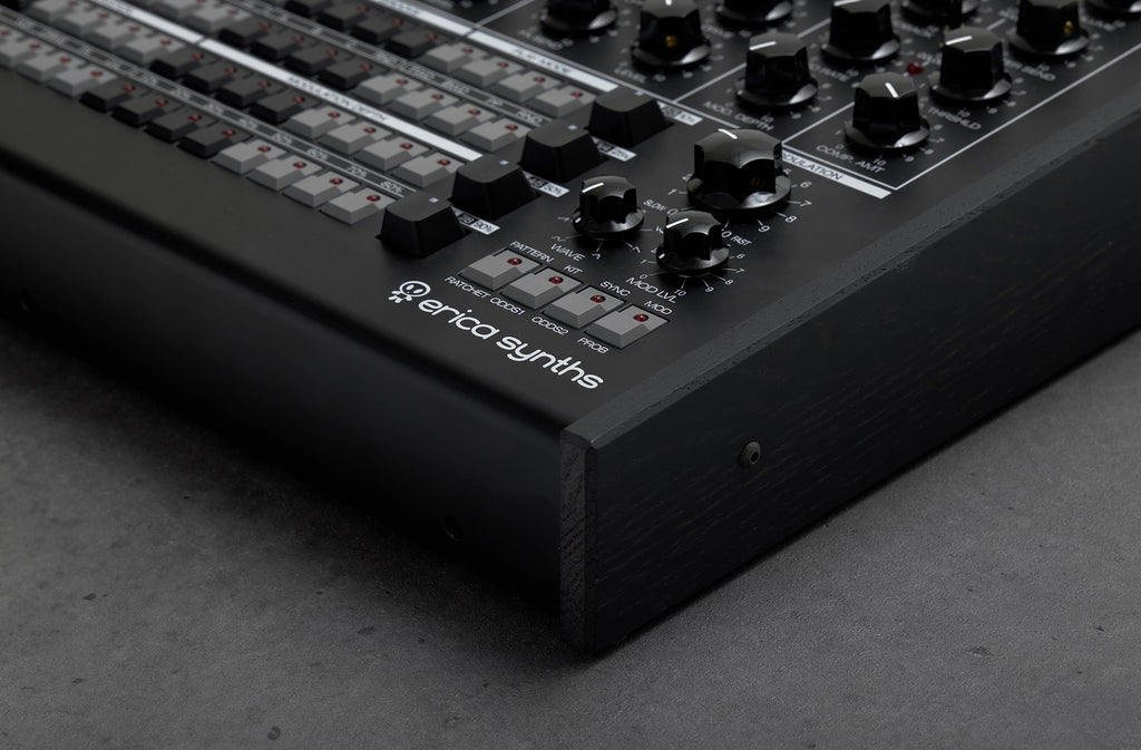 Black Erica Synths Perkons HD-01 drum machine and sampler with knobs, pads, and display, designed for electronic music production.