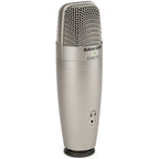 Samson C01U Pro USB microphone with black body and metal grille, set on a desk for professional audio recording.