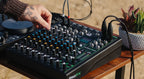 Mackie ProFX10 GO analog mixer with multiple input channels, knobs, and control sliders for live sound and recording setups.