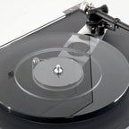 Rega Planar 6 turntable in Polaris Grey with Nd5 cartridge, showcasing the sleek design and tonearm in a close-up view.