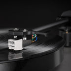 Rega Carbon MM phono cartridge mounted on a turntable, showcasing its sleek design and high-quality build for vinyl playback.