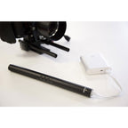 Rode NTG4+ shotgun microphone mounted on a boom pole, professional audio recording equipment for filmmaking or broadcasting.