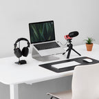 Rode VideoMic NTG camera microphone mounted on tripod, positioned on a clean desk with a blurred background.