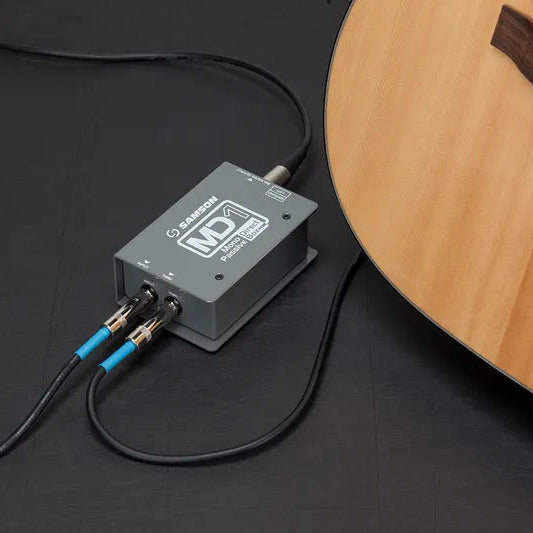 Samson MD1 DI box for guitars, showing connection ports and compact design on a clean white background.