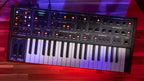 Sequential Fourm keyboard synthesizer with a compact design and multiple control knobs and keys, perfect for music production.