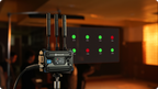 Hollyland Pyro S wireless video receiver connected to a camera, showing a sleek black device with digital display and antenna.