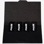 Open pack of Phase Magnetic Stickers for turntable accessories, featuring various designs on a black background.