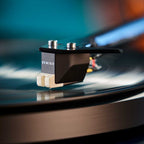 Sumiko Rainier MM phono stylus installed on a turntable cartridge, showcasing the stylus tip for vinyl record playback.