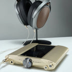 iFi Audio iDSD Valkyrie headphone amplifier and DAC with sleek black design and various input ports, set on a modern desk.