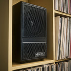 Vestlyd M6C Active in Black placed on a record shelf in a living room