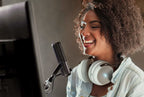 Black Elgato Wave:3 USB microphone on a desktop, showing the sleek design and compact build of the popular streaming microphone.