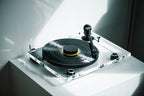 Pro-Ject XA B turntable with wooden plinth and tonearm, shown in a stylish modern setup for high-quality vinyl playback.