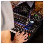 Zoom LiveTrak L-20 digital mixer with multiple faders and control knobs on a sleek black interface.